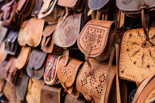 Leather bags in a market stand in Morocco.